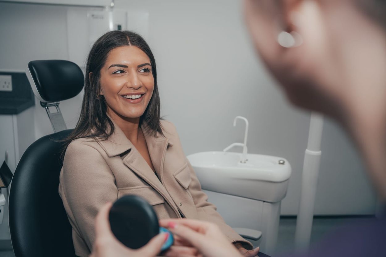Patient talking with a dental clinician in a treatment room
