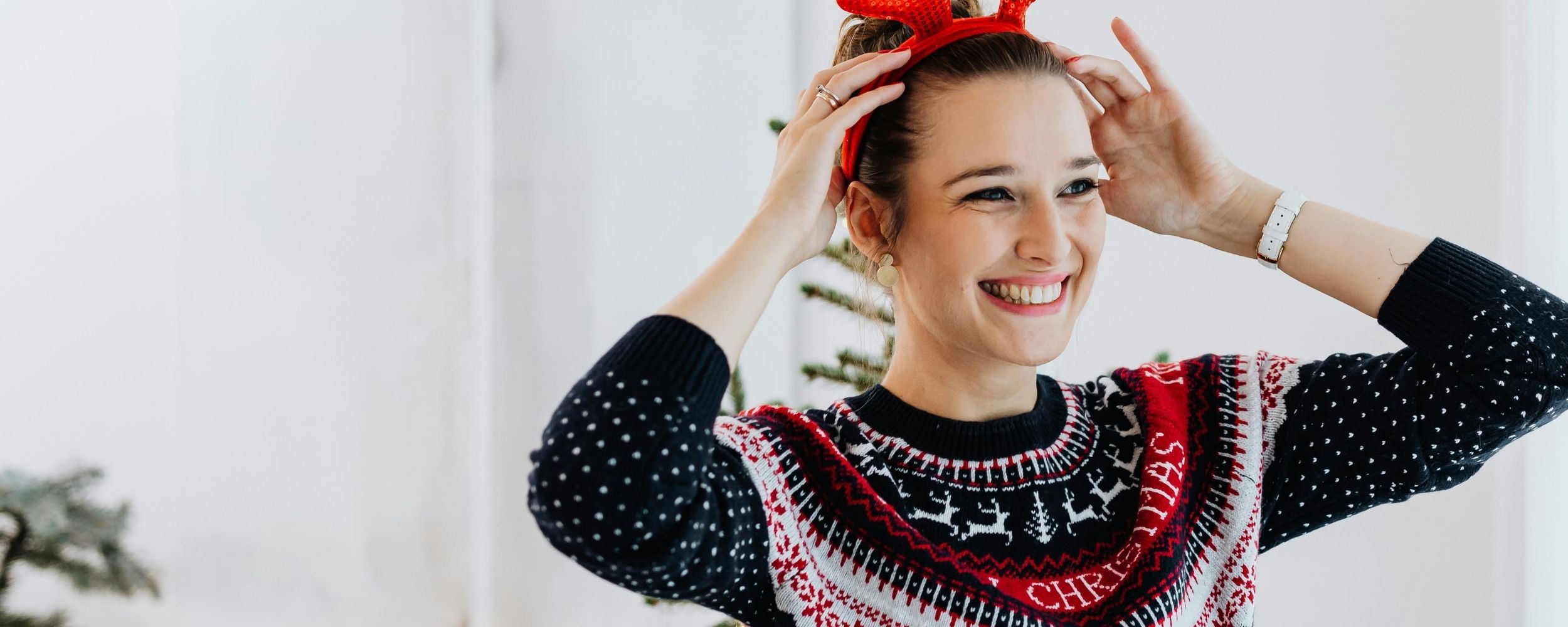 Woman smiling at Christmas – benefits of composite bonding at Oakley Dental Prestwich