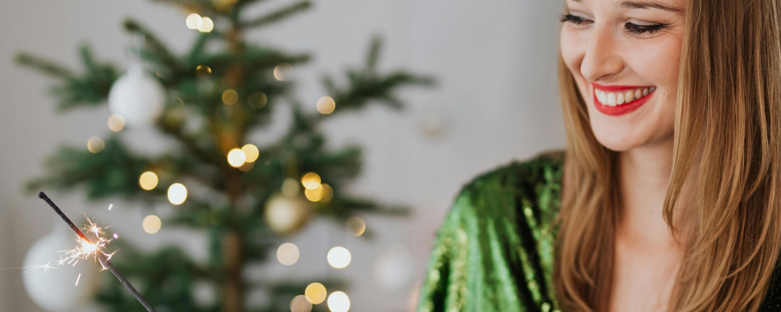 Smiling woman celebrating Christmas – composite bonding offer at Oakley Dental Prestwich